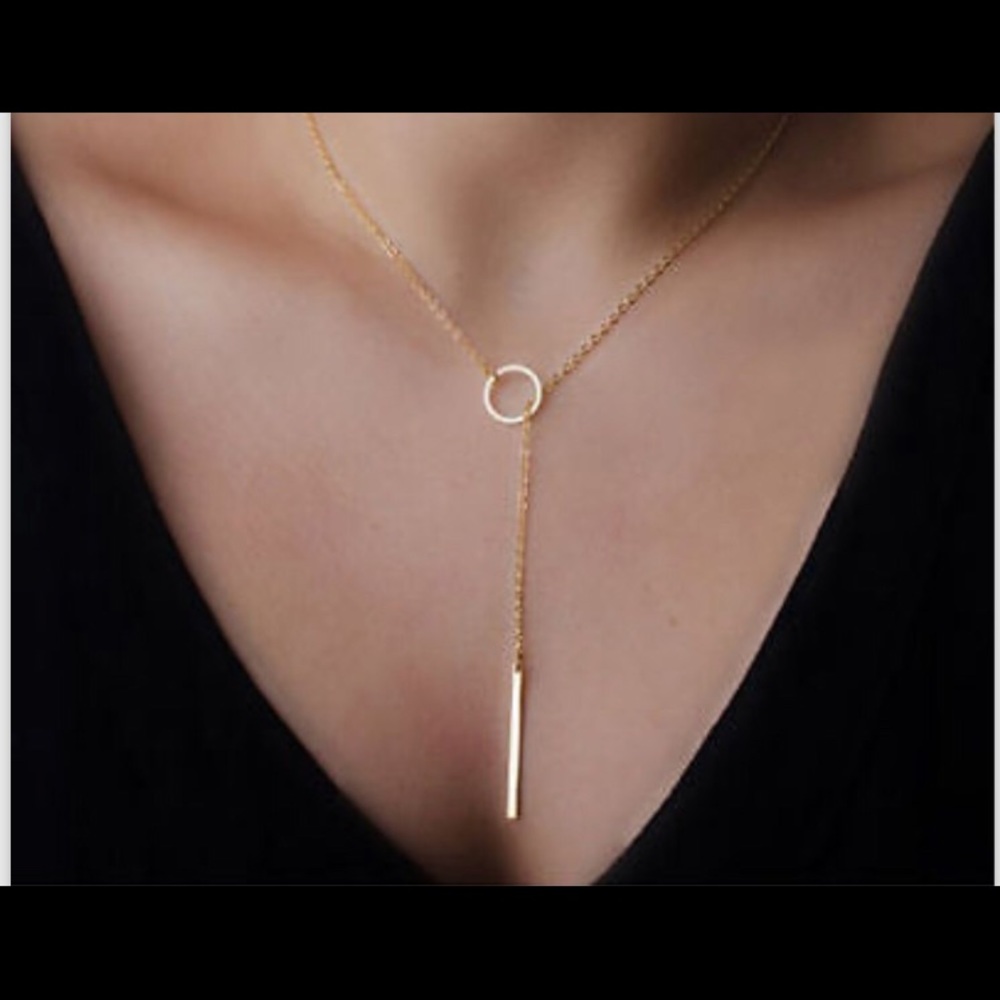 Brand new gold stick lariet necklace.